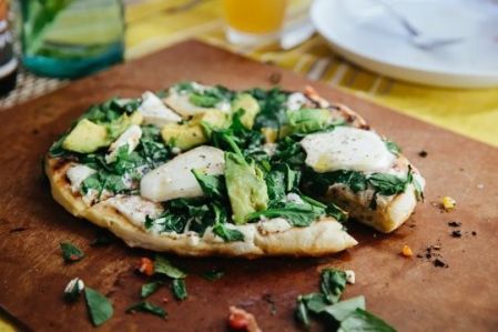White pizza with avocado, spinach and mozzarella