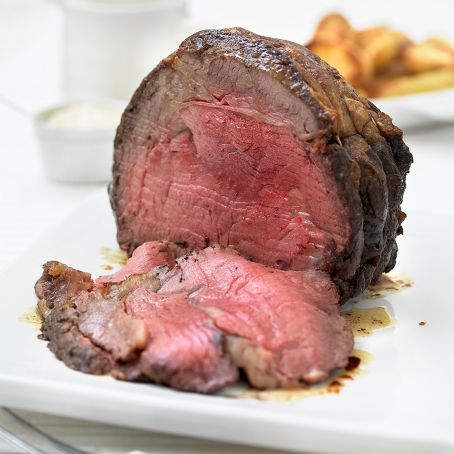 Rolled rib of beef with herb, anchovy and garlic stuffing