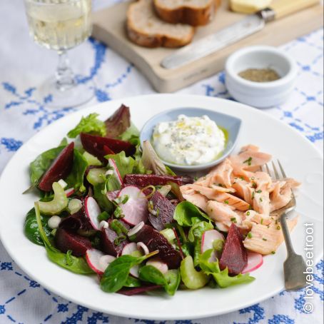 Summer garden salad of traditional beetroot, radish, celery, leaves, spring onions, with smoked trout fillets. Horseradish cream dressing.