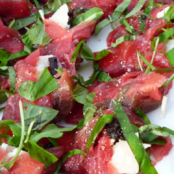 Carpaccio rolls with rocket and Parmesan