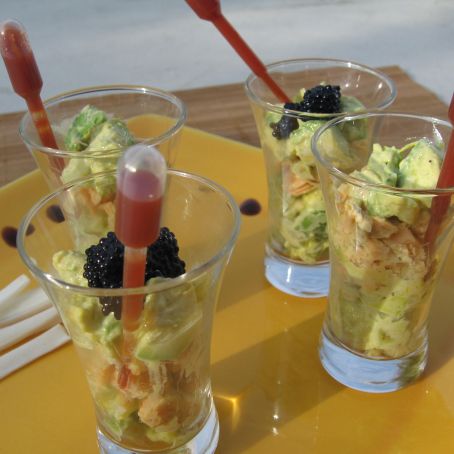 Verrines of salmon and avocado with sauce in their pipettes